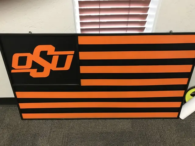 A fabricated steel OSU flag in orange and black, built in the Cook's shop