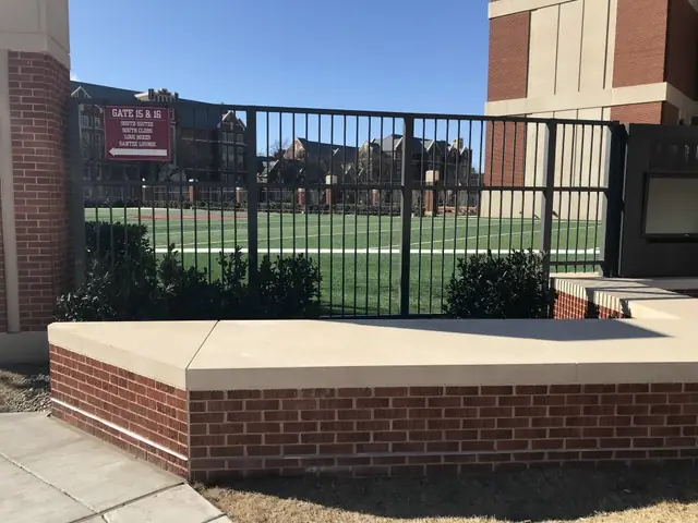 The same stadium fence run at the University of Oklahoma, with a stadium wayfinding sign in frame